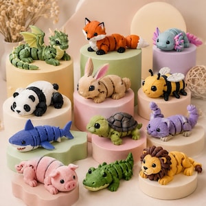 May include: A collection of colorful, segmented animal figurines, including a dragon, fox, panda, rabbit, shark, bee, turtle, cat, pig, alligator, axolotl, and lion. Each figurine is displayed on a small, round pedestal.