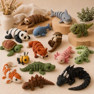 May include: A collection of handmade animal figurines, including a sloth, panda, shark, whale, otter, turtle, fox, bee, axolotl, gecko, koi fish, alligator, stegosaurus, and dragon. The figurines are in various colors and made of a soft material.