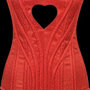 May include: A bright red corset featuring a subtle, tonal floral brocade pattern throughout the fabric. The garment has a sweetheart neckline and a prominent heart-shaped cutout located at the center of the chest, framed by vertical seams.
