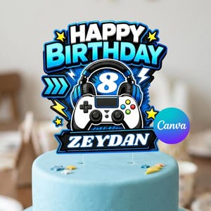 May include: A blue and white gaming-themed cake topper featuring the text HAPPY BIRTHDAY and ZEYDAN. The design includes a white video game controller, black headphones, a large number 8, and yellow lightning bolt and star accents.