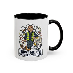 May include: White ceramic mug with a black interior and handle. The mug features a cartoon illustration of an electrician surrounded by electrical wires and tools. Text on the mug reads "TRUST ME, I'VE WATCHED YOUTUBE."