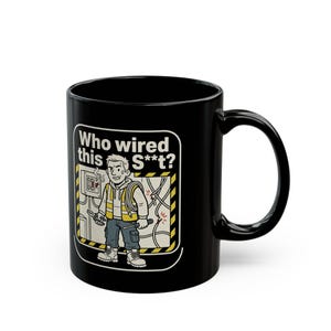 May include: Black ceramic mug with a cartoon electrician and the text "Who wired this S**t?". The illustration shows an electrician looking at a wiring panel. The mug has a curved handle.