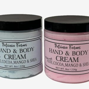 May include: Two jars of hand and body cream, one blue and one pink. Both jars have black lids and labels that read "Petunia Farms Hand & Body Cream Made with Aloe, Cocoa, Mango & Shea Net Wt. 8oz 1 226g"