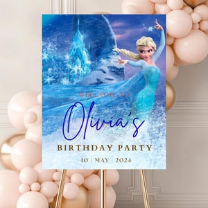 May include: A rectangular birthday party sign featuring a blue icy background with a large ice castle and a blonde character in a light blue dress. The text reads: Welcome to Olivia's Birthday Party, 10 May 2024, in blue and gold lettering.
