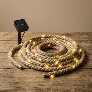 May include: Coiled rope lights with warm white LED bulbs. The rope is a natural beige colour, and the lights are evenly spaced. A small solar panel is attached to the rope. The lights are on a wooden surface.
