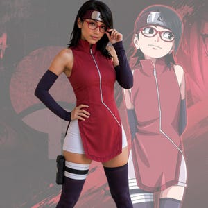 May include: A sleeveless maroon tunic with a front zipper, white shorts, dark purple arm sleeves, and matching thigh-high socks. The outfit includes a maroon headband with a metal plate featuring a leaf symbol and red-framed glasses.