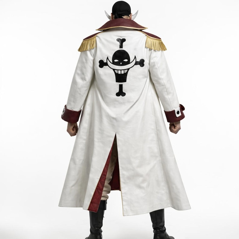 May include: A long white coat with a black skull and crossbones emblem on the back. The coat has red trim on the collar, cuffs, and inner lining. Gold fringe adorns the shoulders. Black boots complete the look.