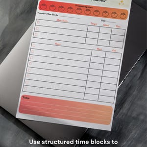 May include: A white Focus Time Planner notepad with a colorful header and footer. The notepad includes sections for Pomodoro time blocks, main tasks, and notes. Text on the notepad reads "Use structured time blocks to increase your productivity."