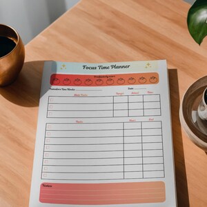 May include: A printable Focus Time Planner with a tomato-themed productivity score section. The planner includes sections for tasks, start and end times, and notes. The text "Focus Timer Planner" is at the top.