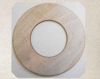 May include: A wooden ring with a circular cutout in the center. The ring is light brown and has a natural wood grain. It is a blank craft supply that can be used for a variety of projects.