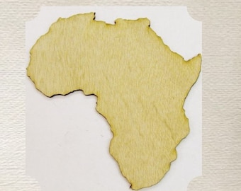 May include: A wooden cutout of the continent of Africa. The cutout is light brown and has a smooth surface.