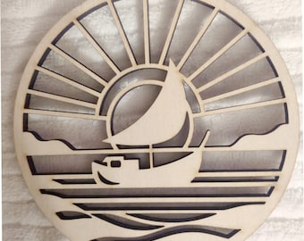 May include: A wooden cutout of a sailboat sailing into a sunset over the ocean. The sun is represented by a circle with rays emanating from it. The waves are depicted with curved lines.