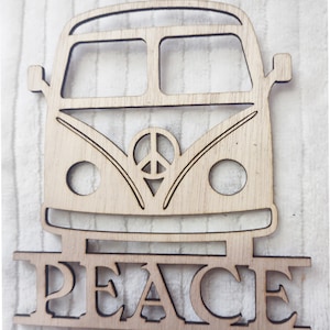 May include: Wooden cutout of a vintage van with a peace sign on the front and the word "PEACE" underneath.