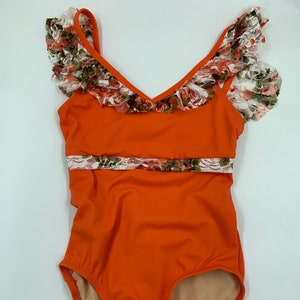 Child XL orange leotard with lace trim and ruffle