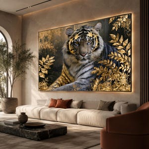 May include: A large rectangular wall art piece featuring a tiger with black and white stripes, surrounded by metallic gold foliage against a dark, moody forest background. The artwork is displayed in a frame with integrated warm backlighting.