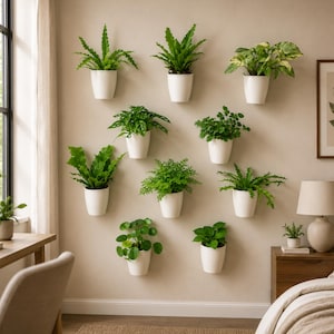 May include: A collection of ten white wall-mounted planters, each containing a different green houseplant. The planters are arranged in a grid pattern on a beige wall, featuring various foliage types including ferns and broad-leafed plants.