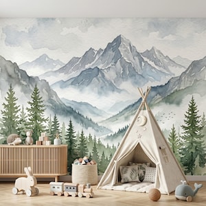 May include: A watercolor mural of a mountain range with green trees and a light blue sky. A beige teepee tent is in the foreground, with a wooden toy train, a wooden toy rabbit, and a wooden cabinet with toys.