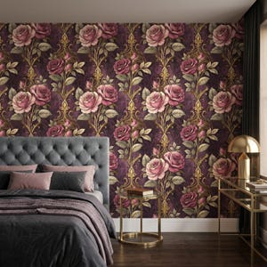 May include: A bedroom with a dark purple floral wallpaper featuring large pink roses and gold accents. The bed has a gray tufted headboard, gray bedding, and pink pillows. A gold side table and lamp are also visible.
