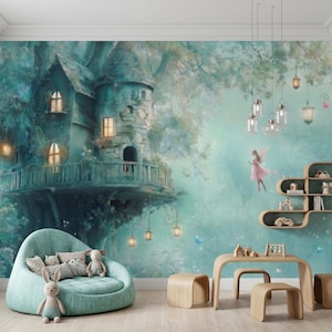 May include: A whimsical children's room with a mural of a treehouse and a fairy. The room features a teal beanbag chair, wooden furniture, and decorative hanging lights. Soft toys and pillows add to the cozy atmosphere.