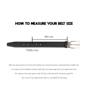 May include: A black leather belt with a silver buckle, illustrating how to measure belt size. The text reads: "HOW TO MEASURE YOUR BELT SIZE." The image shows the belt's middle hole and belt size. The text also explains how to choose the correct belt size.