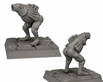 May include: Two gray, stylized figurines of a fish-like creature with humanoid legs. The figures are posed on square, stone-textured bases. One figure faces forward, mouth open, while the other is viewed from the rear.
