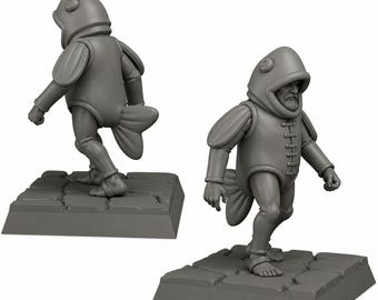 May include: Two gray miniature figurines of a person in a fish costume, one facing forward and the other facing away. The figures are on gray square bases with a stone-like texture. The costume includes a hood, tunic, and a fin-like tail.
