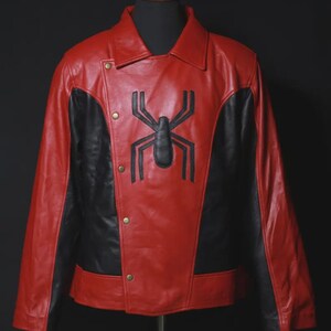 May include: A red and black leather jacket with a large black spider emblem on the chest. The jacket features a collared neckline, snap closures, and black panels on the sides. The jacket is displayed on a mannequin.