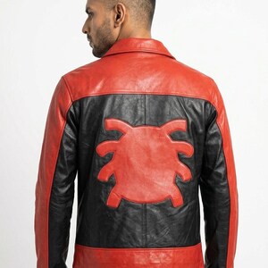 May include: A red and black leather jacket with a unique design on the back. The jacket features a red collar, shoulders, and hem, with black panels and a red emblem. The jacket is a stylish outerwear piece.