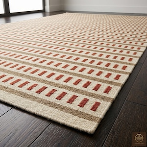 May include: A rectangular area rug featuring a repeating pattern of horizontal stripes in cream, tan, and burnt orange. The design consists of alternating bands of solid tan and rows of short, dashed burnt orange lines on a cream background.