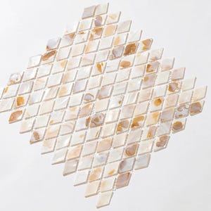 May include: A diamond-shaped mosaic tile sheet composed of small, individual rhombus-shaped pieces. The tiles feature a mix of iridescent white, cream, and translucent amber tones, creating a varied, natural-looking pattern across the entire surface.