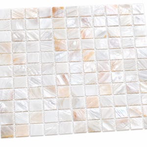 May include: A square mosaic tile sheet composed of small, individual square pieces of iridescent mother-of-pearl. The tiles feature a natural color palette of white, cream, and soft peach tones with a reflective, pearlescent surface finish.