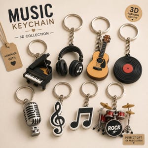 May include: A collection of eight music-themed keychains featuring a black piano, black headphones, a wooden acoustic guitar, a black vinyl record, a silver microphone, a black treble clef, a black musical note, and a red drum set with cymbals.