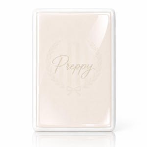 May include: A rectangular, glossy, light beige plaque with a white border. The center features the word Preppy in a cursive script, surrounded by a faint laurel wreath design and a small bow at the bottom, all in a subtle, light-colored tone.