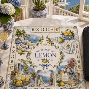 May include: A Mediterranean Lemon themed Mahjong game set with a decorative mat featuring lemons, coastal scenes, and the text "Mediterranean Lemon." Includes a black carrying case, a blue and white patterned plate, and a vase of blue hydrangeas.