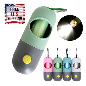 May include: A dog waste bag dispenser in green, gray, and yellow with a built-in flashlight. The dispenser has a carabiner clip and a button. Additional dispensers in pink, green, blue, and white are also shown.