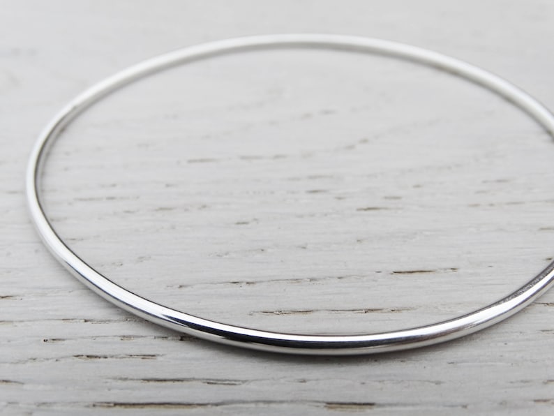 May include: A simple silver bangle bracelet, a classic and timeless piece of jewelry.