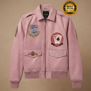 May include: Pink leather jacket with multiple patches, including a playing card design and the text "VP-21". The jacket has a zip-up front, two front pockets, and a "Best Seller" badge.