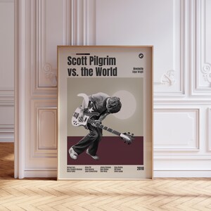 Peut inclure: Une affiche de film verticale pour Scott Pilgrim vs. the World présentant une illustration en noir et blanc d'une personne jouant de la guitare basse. Le design inclut le titre, le réalisateur, les acteurs et l'année 2010 en mise en page.