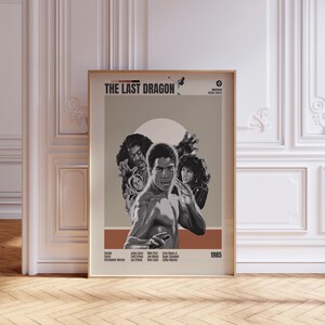 May include: A framed movie poster for "The Last Dragon" with a sepia-toned background. The poster features a central image of a man in a fighting stance, surrounded by other characters. The title and the year 1985 are displayed prominently.