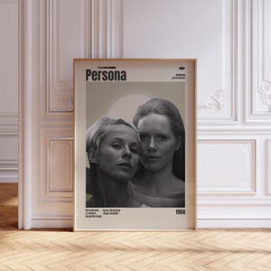 May include: A framed movie poster for the film "Persona" featuring two women in a black and white photograph. The poster has the title "Persona" in a bold font, with the year "1966" at the bottom.