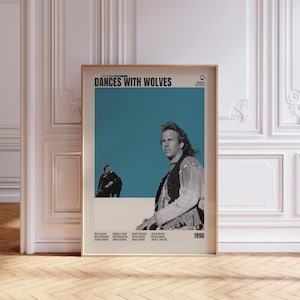 May include: A framed poster for the film "Dances With Wolves", featuring a teal backdrop and images of actors. The poster has a beige border and the year 1990 is visible. The poster is displayed against a white wall with decorative molding.
