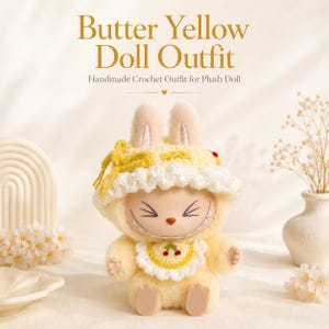 May include: A plush doll wearing a butter yellow crochet outfit consisting of a bonnet with a yellow bow and a scalloped white trim, and a matching bib featuring a small red cherry graphic. The text Butter Yellow Doll Outfit Handmade Crochet Outfit for Plush Doll is visible above the doll.