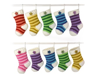 May include: A set of 10 colourful striped crocheted Christmas stockings hanging on a white rod. Each stocking has a white star with glitter on the front.