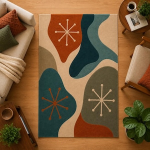 May include: A rectangular area rug featuring a cream background with large, organic, flowing shapes in shades of teal, olive green, and burnt orange. The design includes three white starburst patterns with thin lines and circular endpoints.