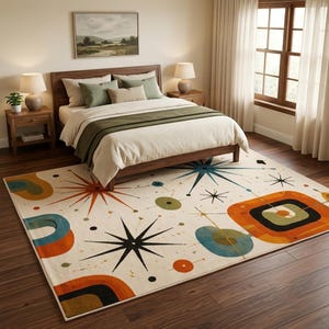 May include: A rectangular area rug featuring a cream background with a repeating pattern of black starbursts, orange and teal geometric shapes, and small circles. The rug is positioned on a dark wood floor in a bedroom with a wooden bed frame.