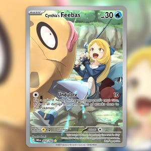 May include: A trading card featuring "Cynthia's Feebas." The card has a colorful illustration of a blonde girl in a blue outfit fishing with a large, tan creature. The card includes text such as "Undulate" and "HP 30."