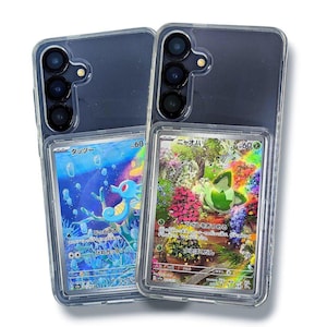 May include: Two clear phone cases with colorful trading cards inside. One card features a blue seahorse in an underwater scene, and the other showcases a green creature in a floral garden. The cases have a dark gray back and a clear frame.