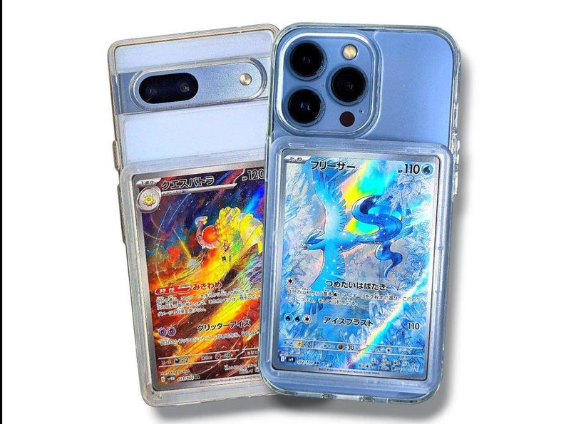 May include: Two smartphones, one light blue and one silver, each encased in clear protective cases. Each case holds a collectible trading card with Japanese text and colorful illustrations. The cards feature a fiery creature and a blue bird.