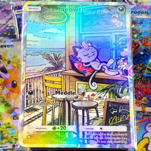 May include: A holographic Pokémon trading card featuring Alolan Meowth relaxing on a pillow. The card has a colorful, tropical scene with text that reads "Meddle!" and other game-related details. The card is surrounded by other Pokémon cards.