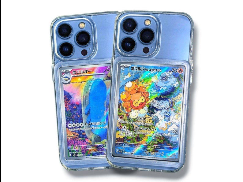 May include: Two clear phone cases with blue backs, each holding a Pok&eacute;mon trading card. One card features a blue whale-like creature, the other an orange and yellow character. The cards have Japanese text and colorful holographic backgrounds.